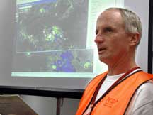 NASA ER-2 aircraft pilot David Wright briefs NOAA and NASA Scientist after his 8+ hour flight over hurricane Dennis. Wednesday July 6, 2005. Photo Credit: "NASA/Bill Ingalls"